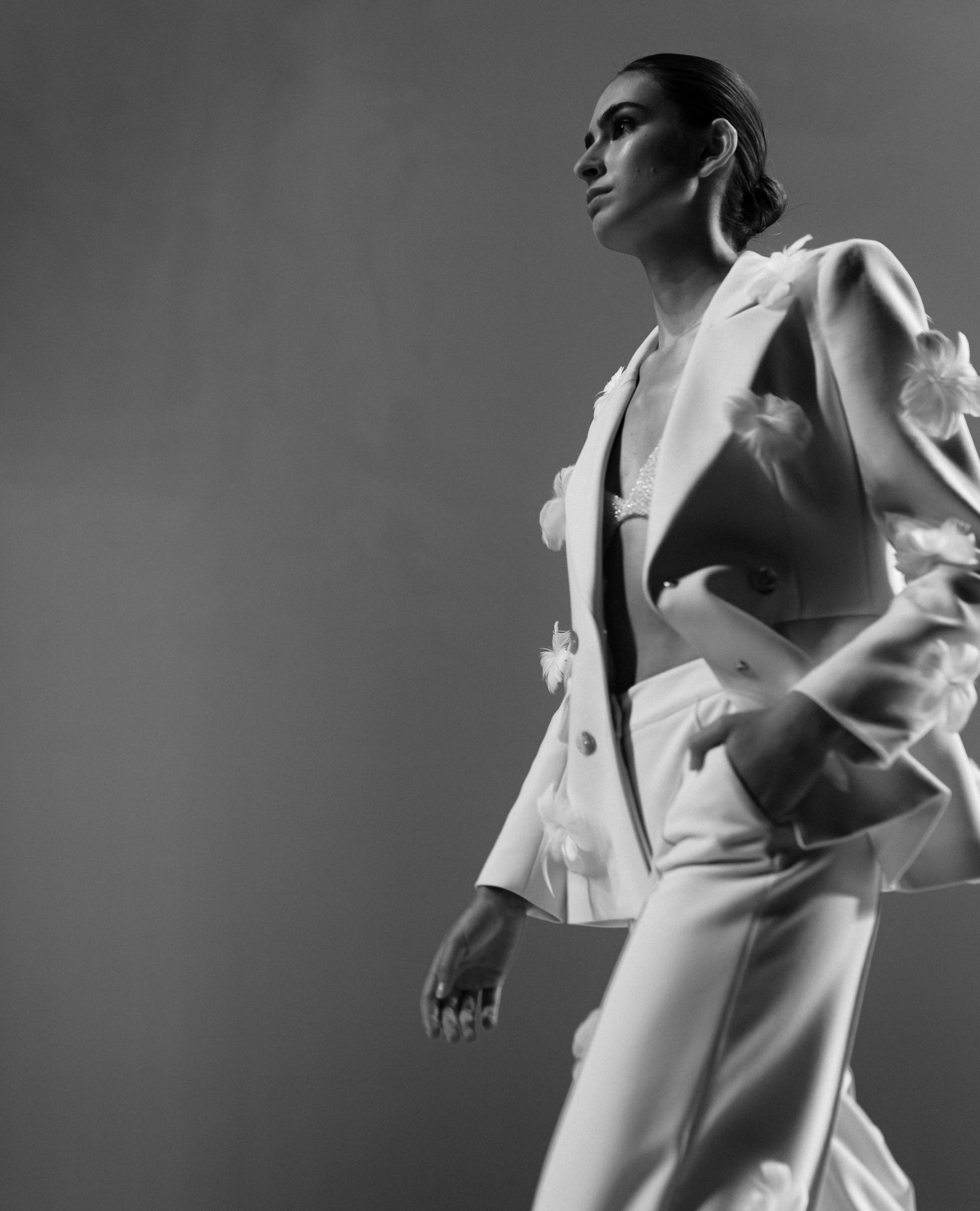 Woman in a tailored white suit in an editorial fashion portrait